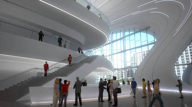 Circulation moves through open, curved paths and gentle ramps, creating a seamless visitor experience.